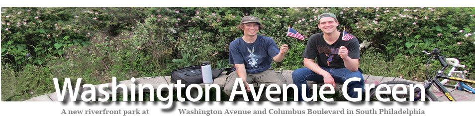 two bicyclists holding small American flags